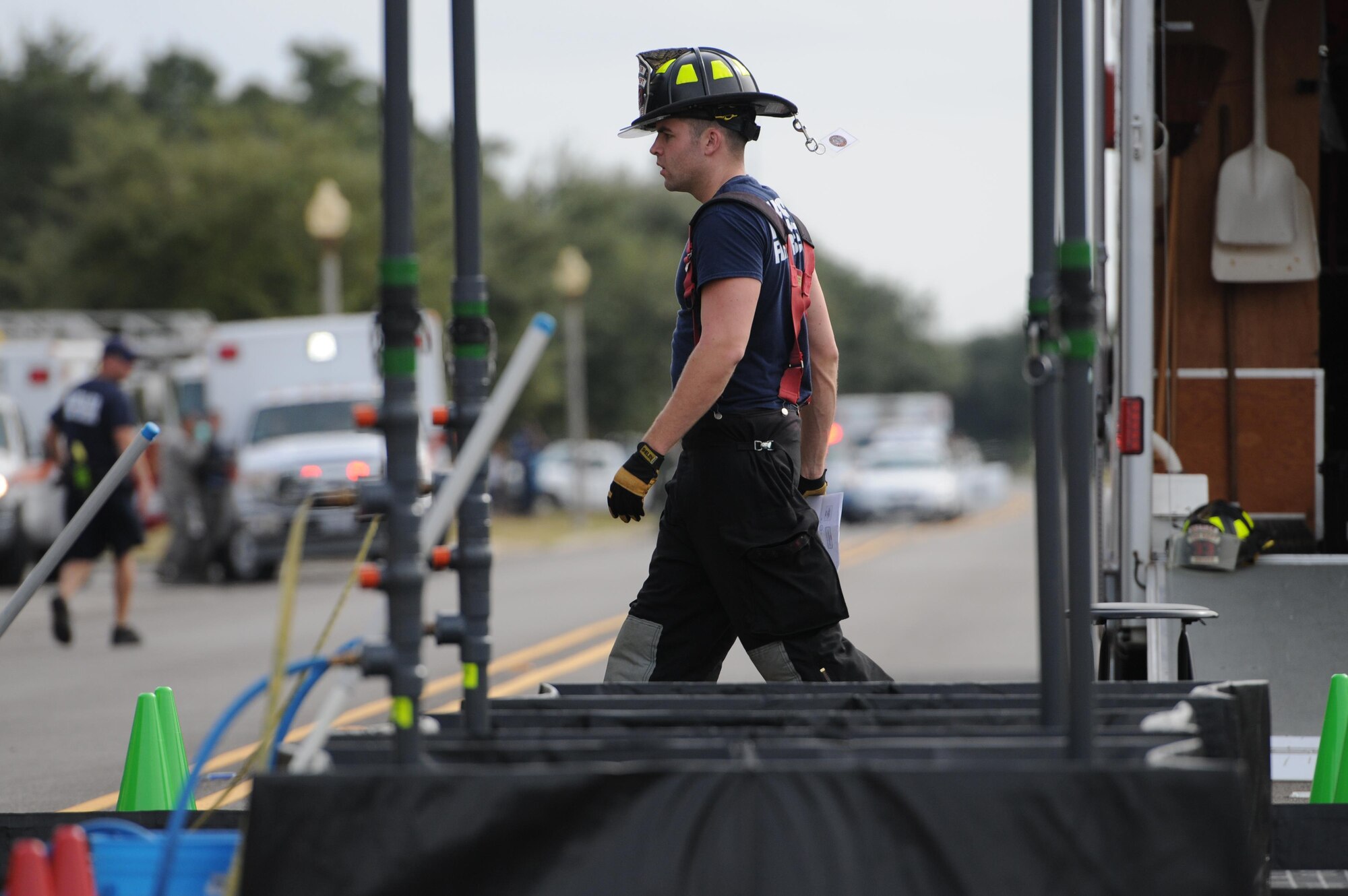 Staff Sgt. John Hood, 81st Infrastructure Division firefighter, assembles a HAZMAT decontamination site for “victims” during a Chemical, Biological, Radiological and Nuclear exercise scenario, Oct. 22, 2015, Keesler Air Force Base, Miss. The Force Protection Condition exercise scenario included an intruder simulating releasing gas to cause a mass casualty event. Airmen who were returning from physical training simulated receiving skin, eye and lung burns from exposure to the chemical. (U.S. Air Force photo by Kemberly Groue)