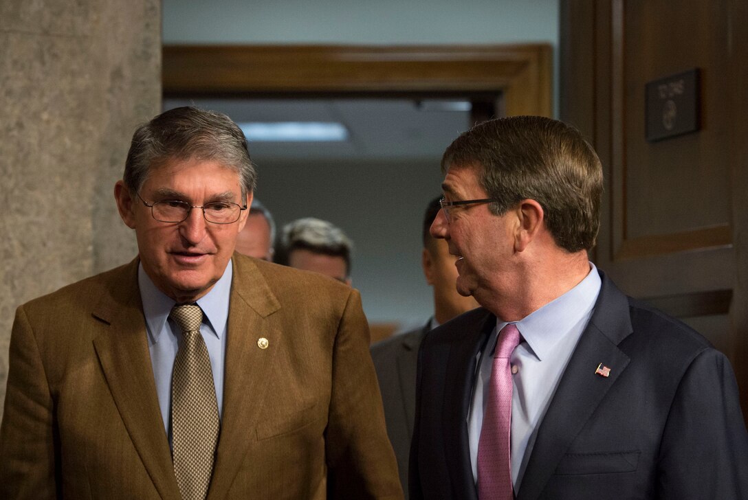 Defense Secretary Ash Carter, right, speaks with U.S. Sen. Joe Manchin upon arriving to testify before the Senate Armed Services Committee on U.S. military strategy in the Middle East in Washington, D.C., Oct. 27, 2015. DoD photo by Air Force Senior Master Sgt. Adrian Cadiz