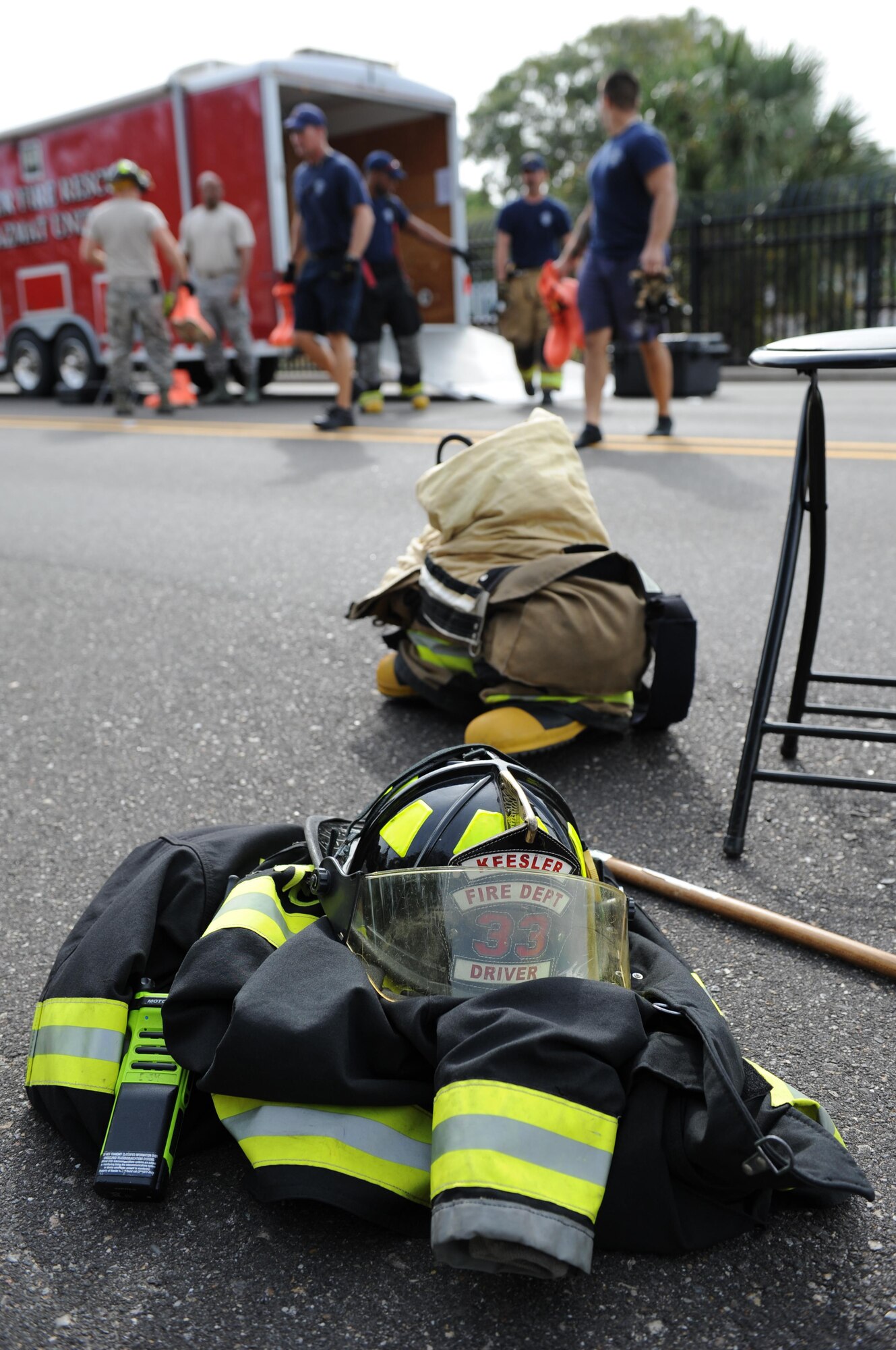 Keesler firefighter equipment is gathered on scene as firefighters transition into protective level-A suits during a Chemical, Biological, Radiological and Nuclear exercise scenario, Oct. 22, 2015, Keesler Air Force Base, Miss. The Force Protection Condition exercise scenario included an intruder simulating releasing gas to cause a mass casualty event. Airmen who were returning from physical training simulated receiving skin, eye and lung burns from exposure to the chemical. (U.S. Air Force photo by Kemberly Groue)