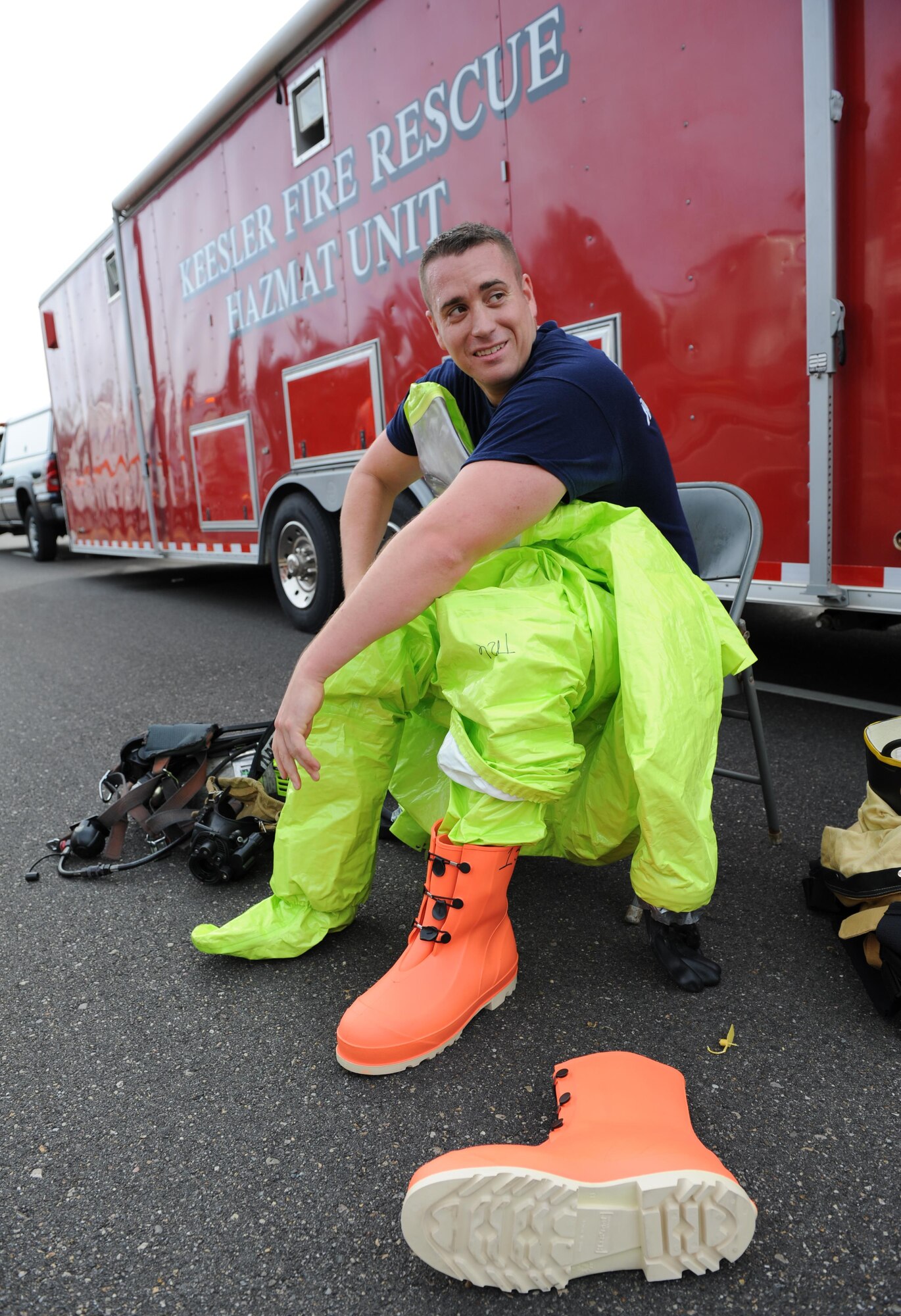 Staff Sgt. Nicholas Fasola, 81st Infrastructure Division firefighter, dresses into a protective level-A suit for entry into the contamination zone during a Chemical, Biological, Radiological and Nuclear exercise scenario, Oct. 22, 2015, Keesler Air Force Base, Miss. The Force Protection Condition exercise scenario included an intruder simulating releasing gas to cause a mass casualty event. Airmen who were returning from physical training simulated receiving skin, eye and lung burns from exposure to the chemical. (U.S. Air Force photo by Kemberly Groue)