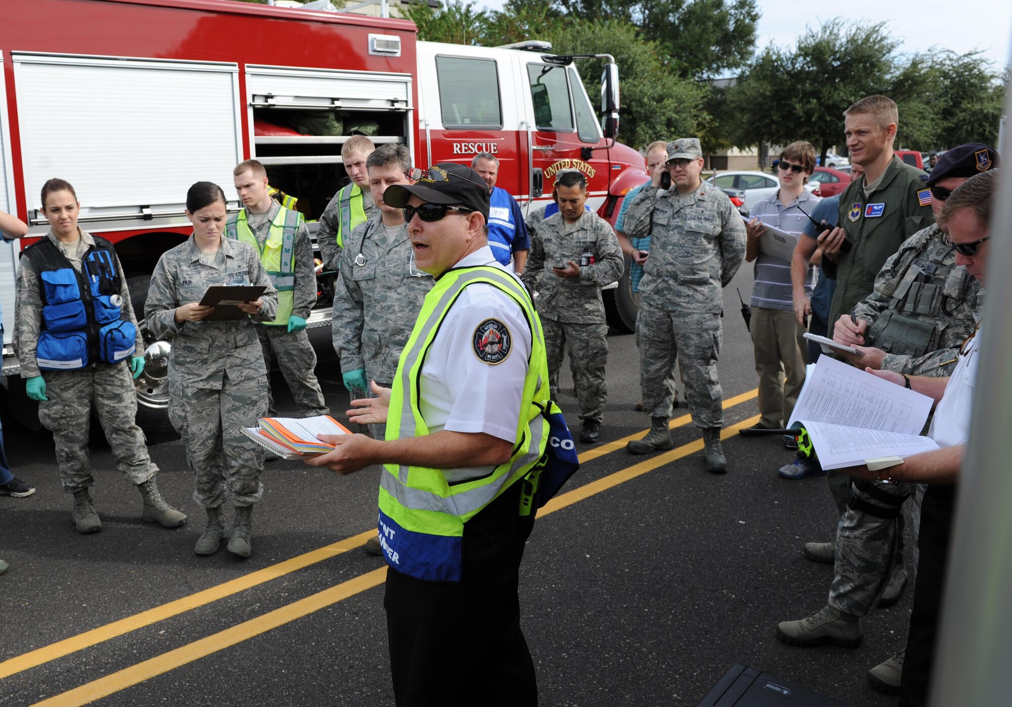 James Donnett, 81st Infrastructure Division fire chief, briefs the incident action plan during a Chemical, Biological, Radiological and Nuclear exercise scenario, Oct. 22, 2015, Keesler Air Force Base, Miss. The Force Protection Condition exercise scenario included an intruder simulating releasing gas to cause a mass casualty event. Airmen who were returning from physical training simulated receiving skin, eye and lung burns from exposure to the chemical. (U.S. Air Force photo by Kemberly Groue)