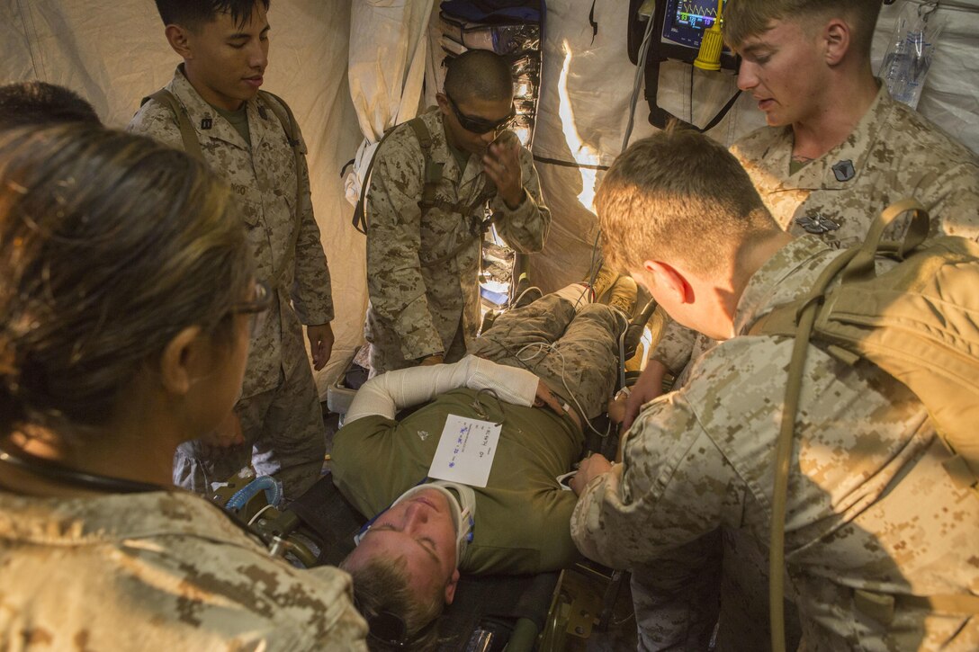 Sailors treat a simulated patient during a casualty evacuation exercise at Fire Base Burt, Chocolate Mountain Aerial Gunnery Range, Calif., Oct. 22, 2015. U.S. Marine Corps photo by Lance Cpl. Roderick L. Jacquote