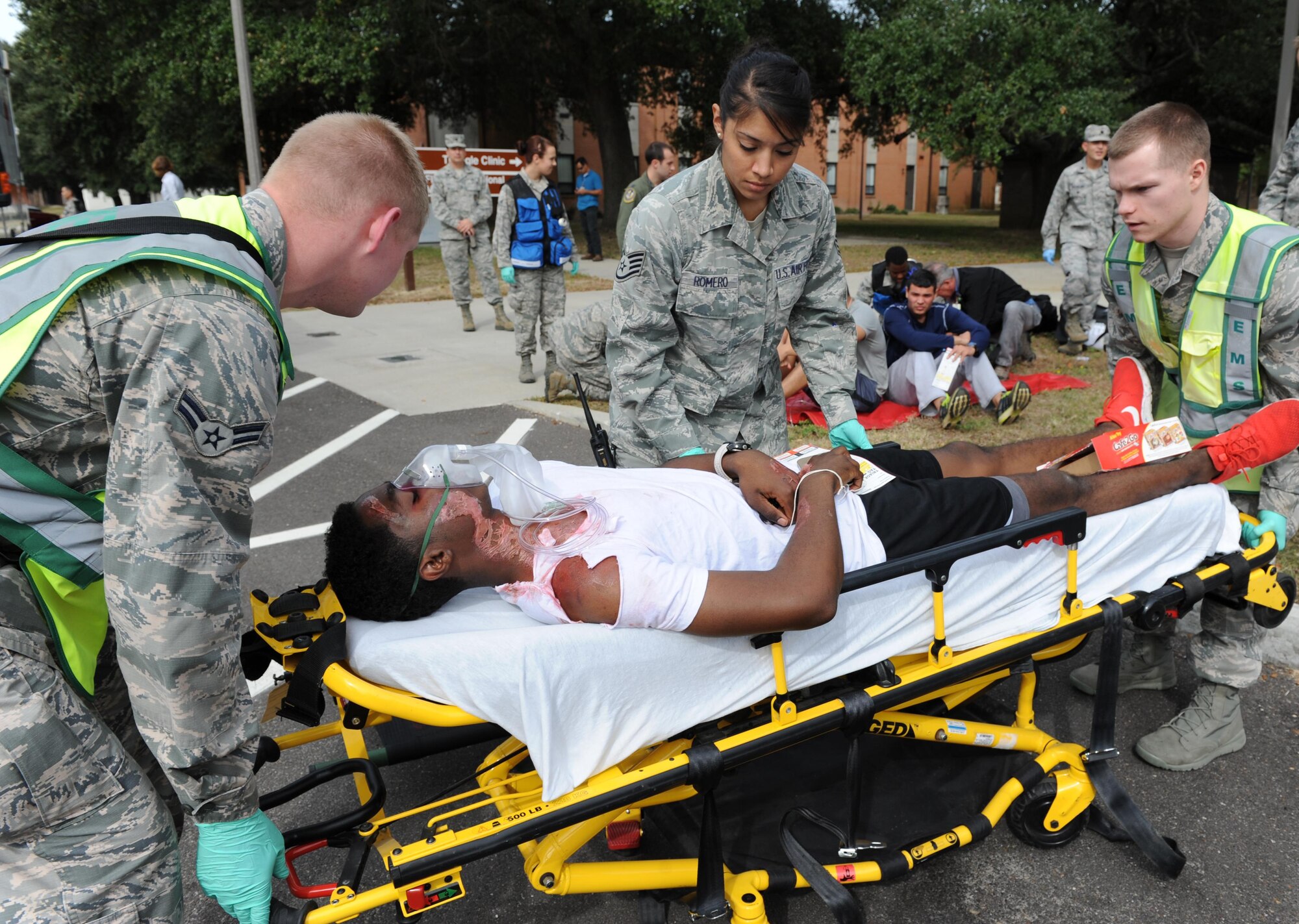 Airman 1st Class Sirtajh Hamilton, 81st Surgical Operations Squadron medical technician, portrays a “victim” receiving treatment from medical personnel during a Chemical, Biological, Radiological and Nuclear exercise scenario, Oct. 22, 2015, Keesler Air Force Base, Miss. The Force Protection Condition exercise scenario included an intruder simulating releasing gas to cause a mass casualty event. Airmen who were returning from physical training simulated receiving skin, eye and lung burns from exposure to the chemical. (U.S. Air Force photo by Kemberly Groue)