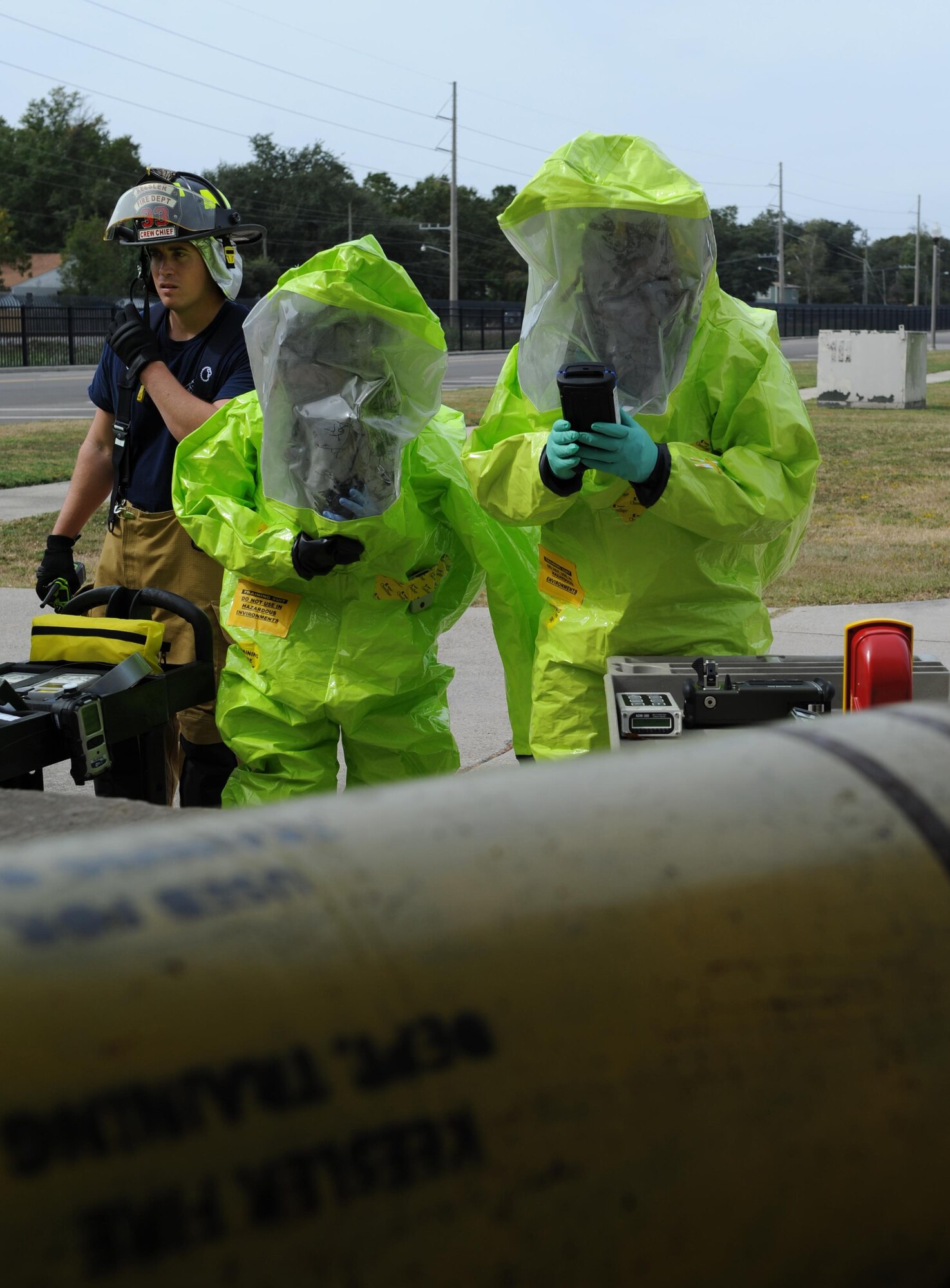 Staff Sgt. Nicholas Fasola, 81st Infrastructure Division firefighter, escorts 81st Aerospace Medicine Squadron bioenvironmental engineering technicians as they test for hazardous vapors in the air during a Chemical, Biological, Radiological and Nuclear exercise scenario, Oct. 22, 2015, Keesler Air Force Base, Miss. The Force Protection Condition exercise scenario included an intruder simulating releasing gas to cause a mass casualty event. Airmen who were returning from physical training simulated receiving skin, eye and lung burns from exposure to the chemical. (U.S. Air Force photo by Kemberly Groue)