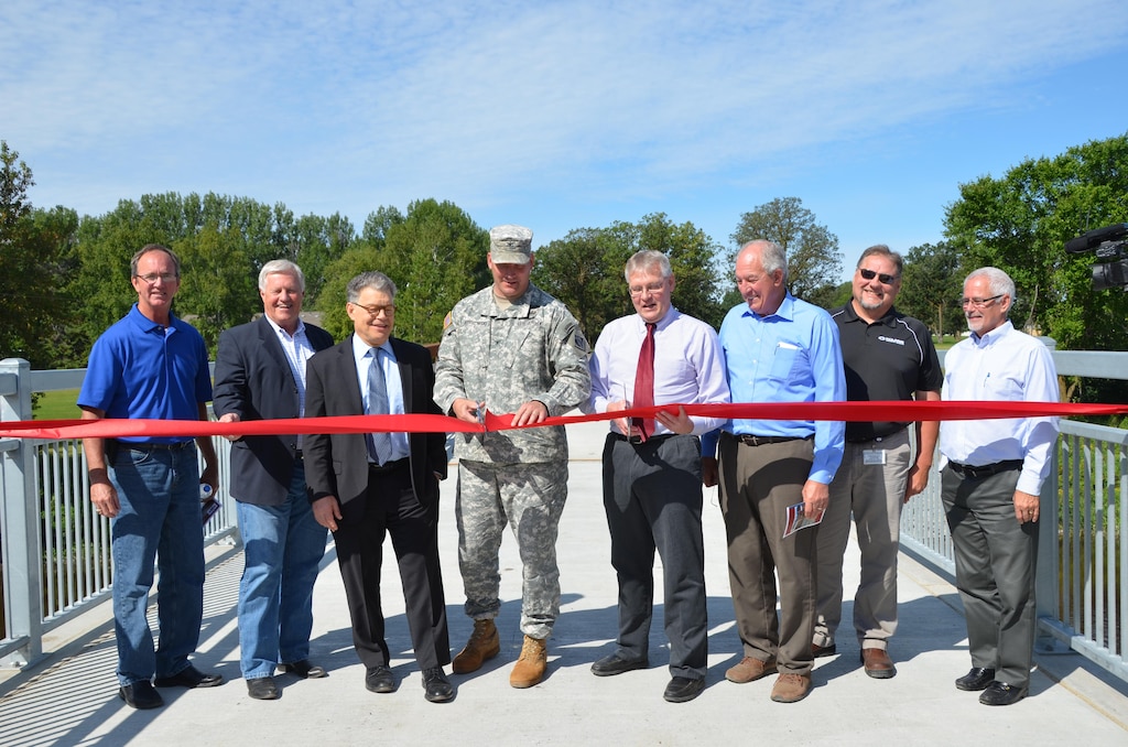 ROSEAU, Minn. - From left, state Rep. Dan Fabian, U.S. Rep. Collin Peterson, U.S. Sen. Al Franken, St. Paul District Commander Col. Dan Koprowski, Roseau, Minn., Mayor Jeffry Peolowski, state
Sen. LeRoy Stumpf, Mark Karl of Polaris Industries, and Minnesota Department of Natural Resources representative Kent Lokkesmoe, dedicated the Roseau Flood Risk Management
project Aug.18.