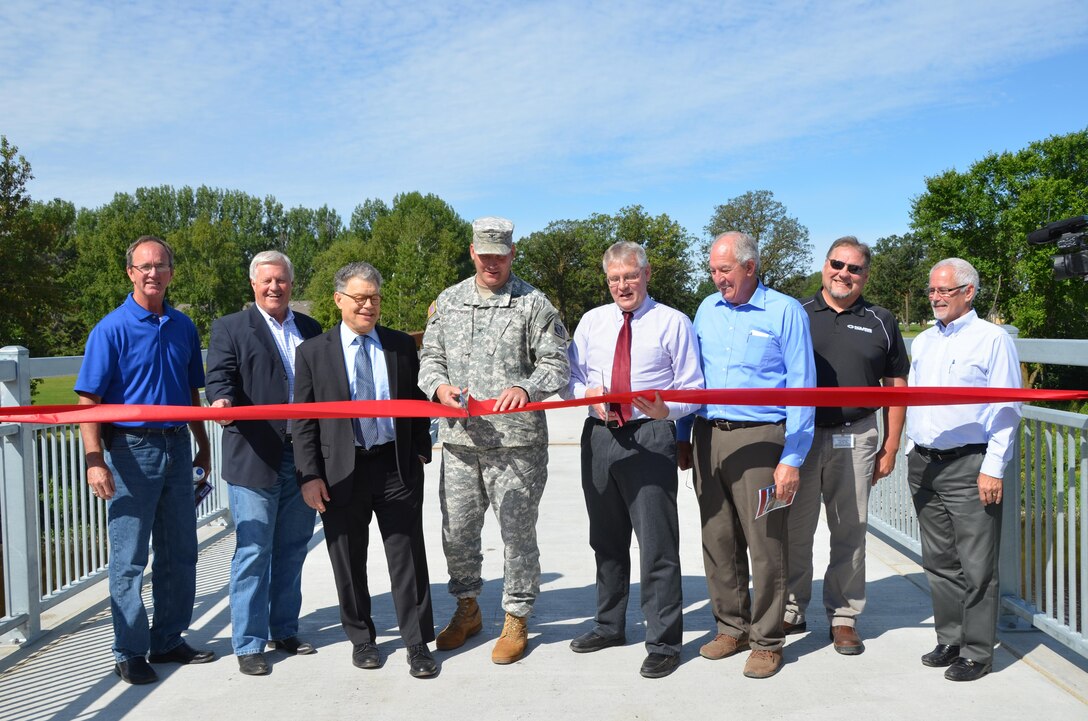 ROSEAU, Minn. - From left, state Rep. Dan Fabian, U.S. Rep. Collin Peterson, U.S. Sen. Al Franken, St. Paul District Commander Col. Dan Koprowski, Roseau, Minn., Mayor Jeffry Peolowski, state
Sen. LeRoy Stumpf, Mark Karl of Polaris Industries, and Minnesota Department of Natural Resources representative Kent Lokkesmoe, dedicated the Roseau Flood Risk Management
project Aug.18.