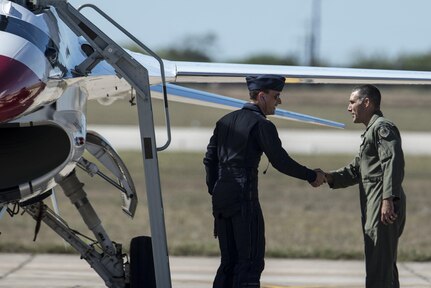 Col. Matt Isler, 12th Flying Training Wing commander, welcomes Maj. Tyler Ellison, U.S. Air Force Air Demonstration Squadron “Thunderbirds” operations officer to Joint Base San Antonio-Randolph Oct. 26, 2015. The Thunderbirds are scheduled to perform at the JBSA Air Show and Open House Oct. 31 and Nov. 1.