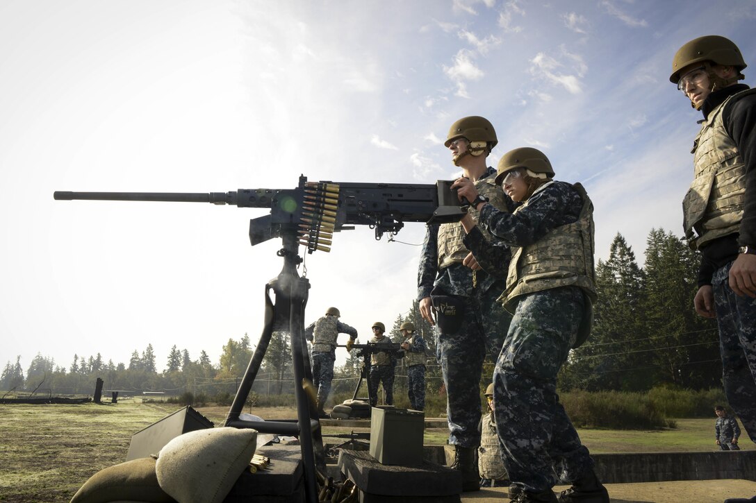 A sailor fires a .50-caliber machine gun during a live-fire exercise on Joint Base Lewis McChord, Wash., Oct. 21, 2015. The sailors, who conducted gun qualifications on the base, are assigned to the USS Nimitz. U.S. Navy photo by Petty Officer 3rd Class Lauren K. Jennings