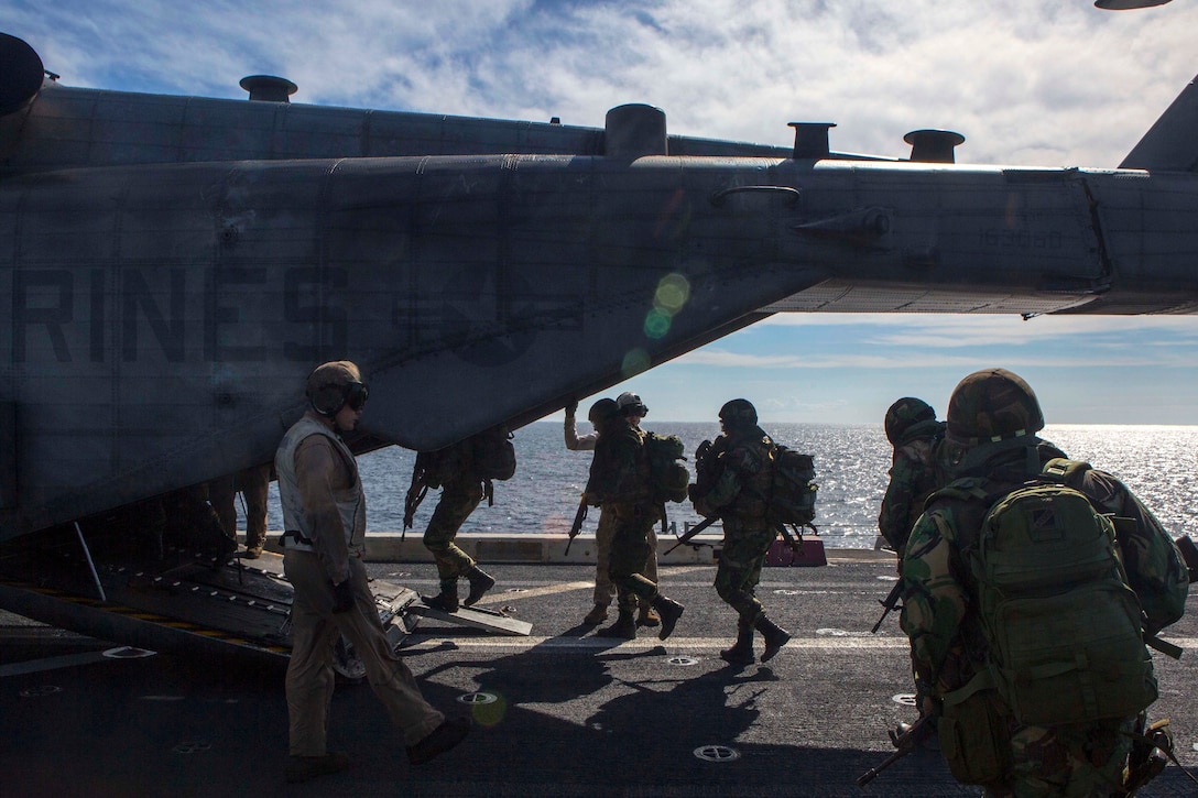 U.S. and Portuguese Marines load into a U.S. Marine Corps CH-53E Sea Stallion helicopter aboard the amphibious transport dock ship USS Arlington in preparation for a combined helicopter-borne assault training near Pinheiro Da Cruz, Praia Da Raposa, Portugal, Oct. 21, 2015 during exercise Trident Juncture 15. U.S. Marine Corps photo by Sgt. Austin Long 