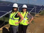 (Left to right) Charlene Woods, DLA Energy Installation Energy contract specialist, and Cindy Ralph, DLA Energy Installation Energy contracting officer, pose for a photograph after conducting a site visit at the solar array being constructed at Fort Detrick, Maryland.