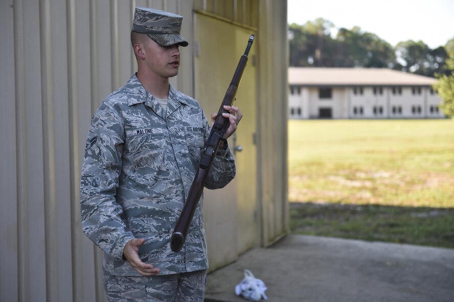 Airman 1st Class Cody Malone, U.S. Air Force Honor Guard mobile training team instructor, demonstrates proper finger placement at Hurlburt Field, Fla., Oct. 16, 2015. A team of three U.S. Air Force Honor Guard mobile training team instructors spent seven days training base honor guard members proper flag presentations, firing party and pallbearer techniques. (U.S. Air Force photo by Senior Airman Jeff Parkinson)
