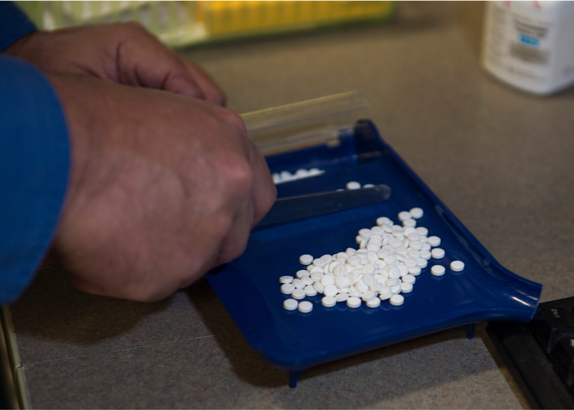 Albert Bosewell, 1st Special Operations Medical Squadron pharmacy technician, counts pills by hand to fill a prescription at Hurlburt Field, Fla., Oct. 13, 2015. Every prescription filled at the pharmacy must pass multiple checks to prevent adverse side effects and ensure safe use by the patient. (U.S. Air Force photo by Airman Kai White/Released)