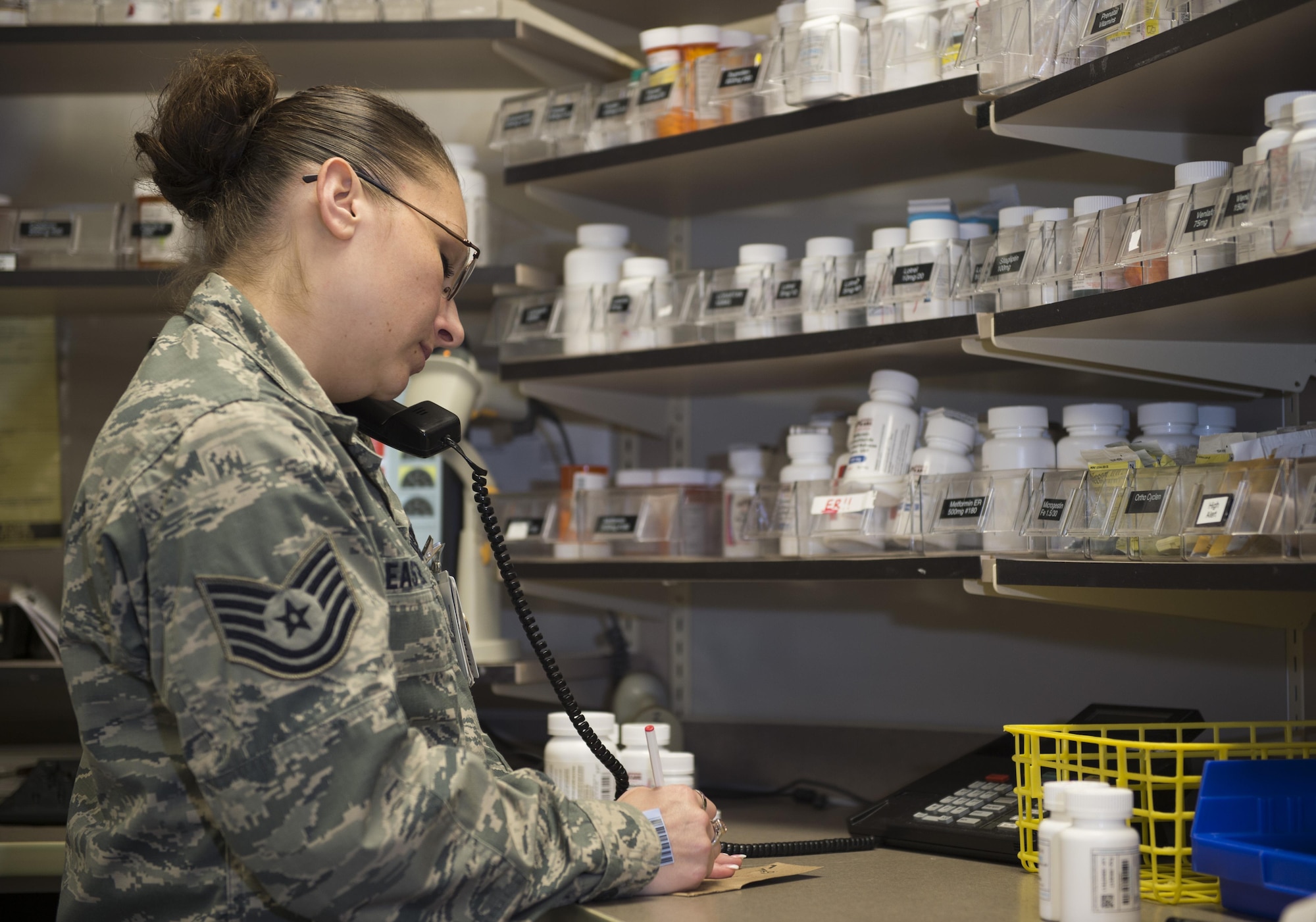 Tech. Sgt. Christina Easter, 1st Special Operations Medical Squadron NCO in charge of pharmacy operations, calls a physician to verify prescription information at Hurlburt Field, Fla., Oct. 13, 2015. Every prescription filled at the pharmacy must pass multiple checks to prevent adverse side effects and ensure safe use by the patient. (U.S. Air Force photo by Airman Kai White/Released)