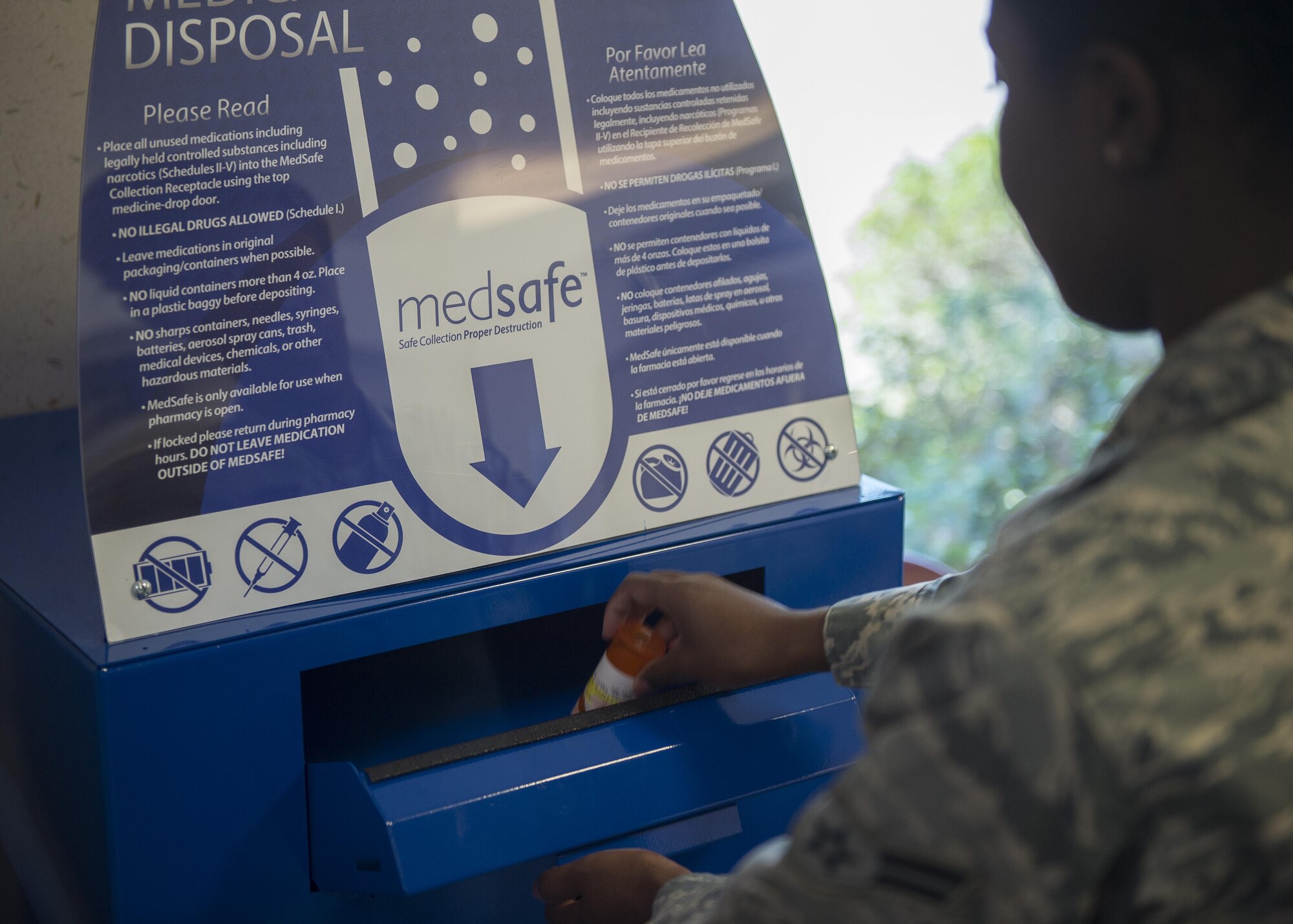 Airman 1st Class Hannah McDonald, 1st Special Operations Medical Squadron pharmacy apprentice, disposes of an unwanted prescription in to a MedSafe container in the pharmacy lobby on Hurlburt Field, Fla., Oct. 13, 2015. The MedSafe container helps patients properly dispose of medication after it has expired to prevent drug abuse and health complications. (U.S. Air Force photo by Airman Kai White/Released)