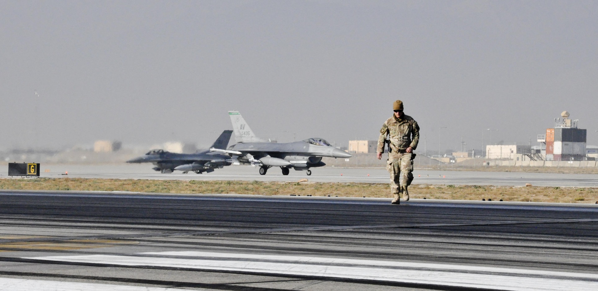 Tech. Sgt. Christopher Fitzgerald, of the 577th Expeditionary Prime Base Engineer Emergency Force Squadron from Al Udeid Air Base, Qatar, inspects the runway as rubber is removed Oct. 22, 2015, at Bagram Airfield, Afghanistan. Foam and biodegradable solvents are used to strip the rubber left behind by the aircraft that land or take off from Bagram in support of Operation Freedom’s Sentinel and NATO’s Resolute Support mission. (U.S. Air Force photo/Tech. Sgt. Nicholas Rau) 