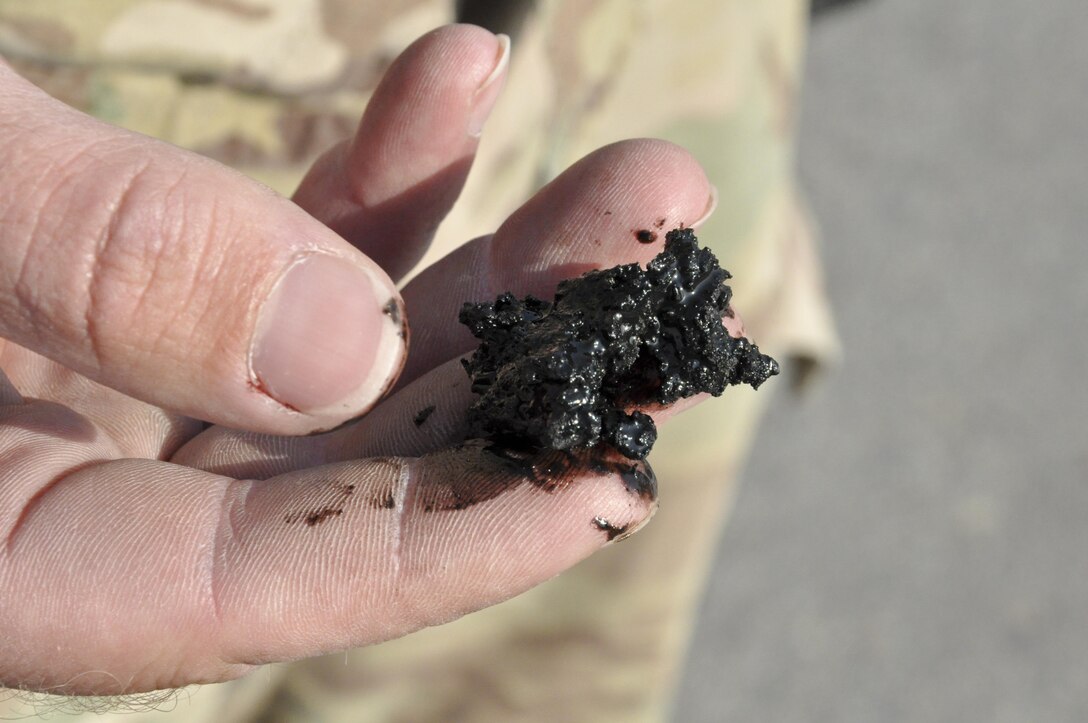 Tech. Sgt. Christopher Fitzgerald, of the 577th Expeditionary Prime Base Engineer Emergency Force Squadron from Al Udeid Air Base, Qatar, removes rubber from the runway Oct. 22, 2015, at Bagram Airfield, Afghanistan. Foam and biodegradable solvents are used to strip the rubber left behind by the aircraft that land or take off from Bagram in support of Operation Freedom’s Sentinel and NATO’s Resolute Support mission. (U.S. Air Force photo/Tech. Sgt. Nicholas Rau) 