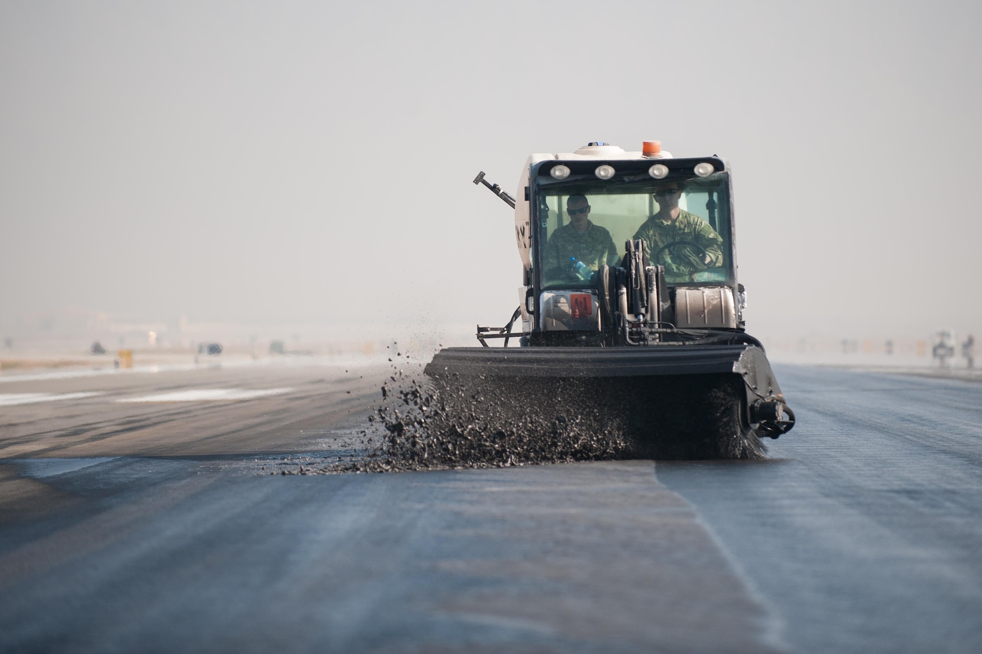 Airmen from the 577th Expeditionary Prime Base Engineer Emergency Force Squadron out of Al Udeid Air Base, Qatar, remove rubber from the runway Oct. 22, 2015, at Bagram Airfield, Afghanistan. Foam and biodegradable solvents are used to strip the rubber left behind by the aircraft that land or take off from Bagram in support of Operation Freedom’s Sentinel and NATO’s Resolute Support mission. (U.S. Air Force photo/Tech. Sgt. Joseph Swafford) 