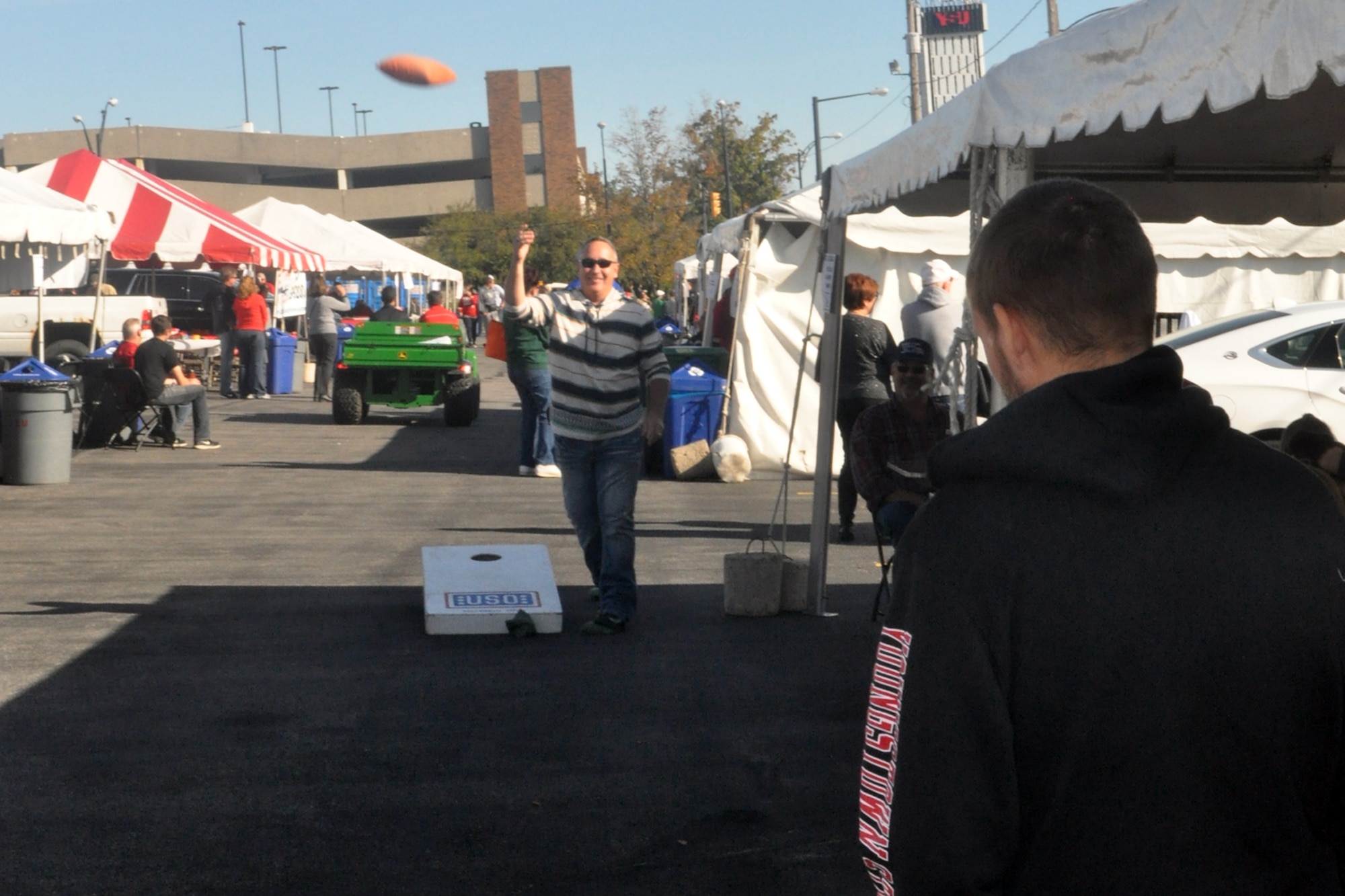 Senior Master Sgt. Donald Cusick, 910th Medical Squadron health services superintendent, shows off his skills during a cornhole match at a tailgate picnic hosted by the 910th Airlift Wing here, Oct. 10, 2015. Nearly 100 football fans representing the wing’s Citizen Airmen, along with their coworkers, families and friends enjoyed a tailgate picnic on a cool but sunny fall afternoon. After tailgating festivities, the 910th group made their way to YSU's Stambaugh Stadium to watch the YSU Penguins 1-AA team fall to the Illinois State Redbirds, 31-29. The event, a fall tradition in recent years for YARS personnel, was presented by the Youngstown Air Reserve Base Community Council and the USO of Northern Ohio. The 910th Force Support Squadron Outdoor Recreation Office and Community Activity Center staff also supported the event. (U.S. Air Force photo/Master Sgt. Bob Barko Jr.)
