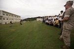 Police officers and officials with the Okinawa Prefectural Police observe a military working dog demonstration during a tour of the Provost Marshal's Office Oct. 23 aboard Camp Foster, Okinawa, Japan. The visit was part of an effort by PMO and OPP to learn about one another's operations and build upon an already fruitful partnership between the two organizations, according to Sgt. Hiroki Ashitomi, an officer with the 2nd Criminal Investigation Section, OPP.