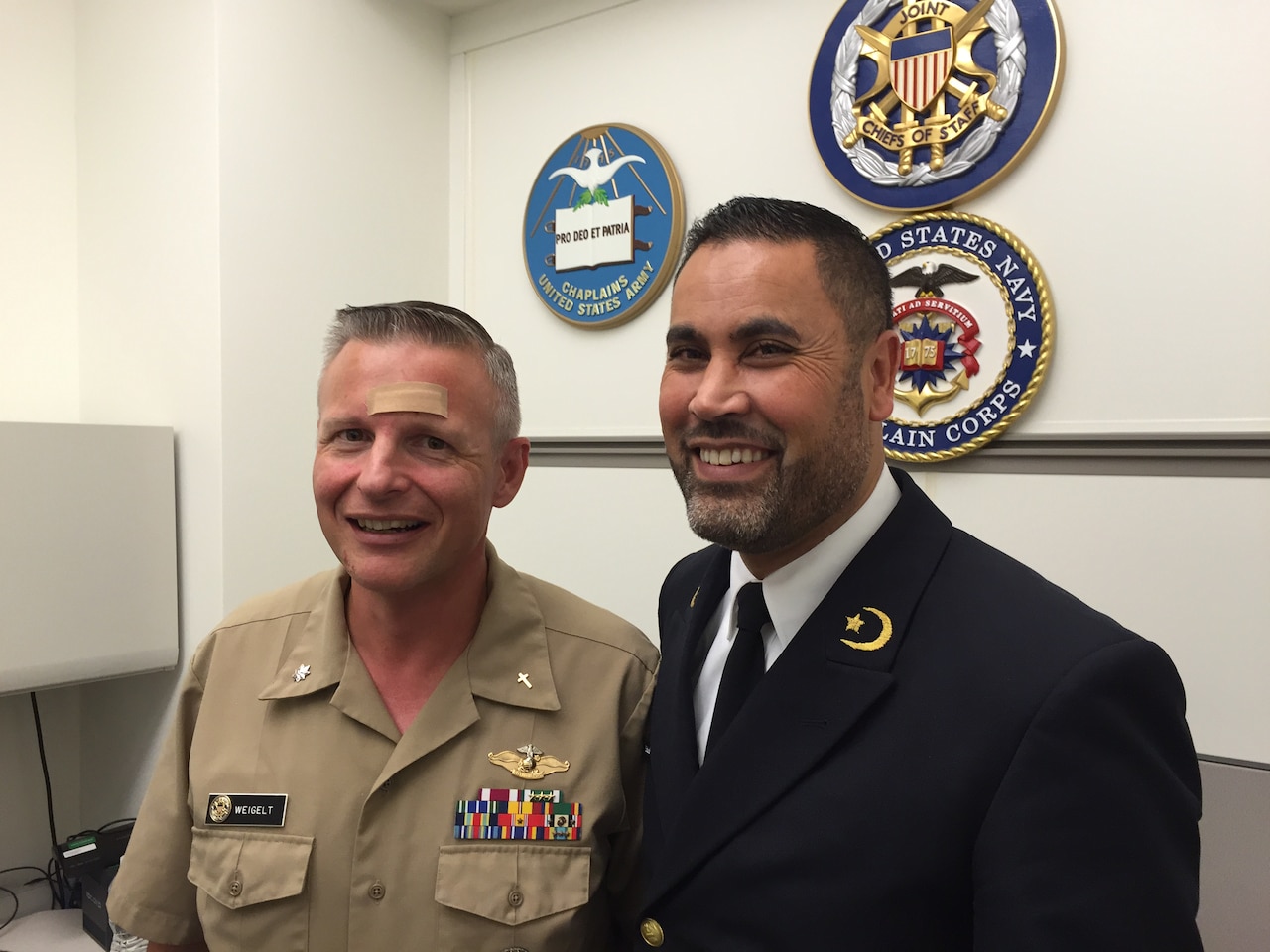 Dutch Navy Capt. (Chaplain) Ali Eddouadi visits with Navy Cmdr. (Chaplain) Brian Weigelt in the Joint Staff chaplain’s office in the Pentagon, Oct. 23, 2015. Eddouaddi, a Muslim chaplain, is visiting his counterparts in Canada and the United States to build a network to help in countering the message of the Islamic State of Iraq and the Levant and to find ways to work together in normal settings. DoD photo by Jim Garamone