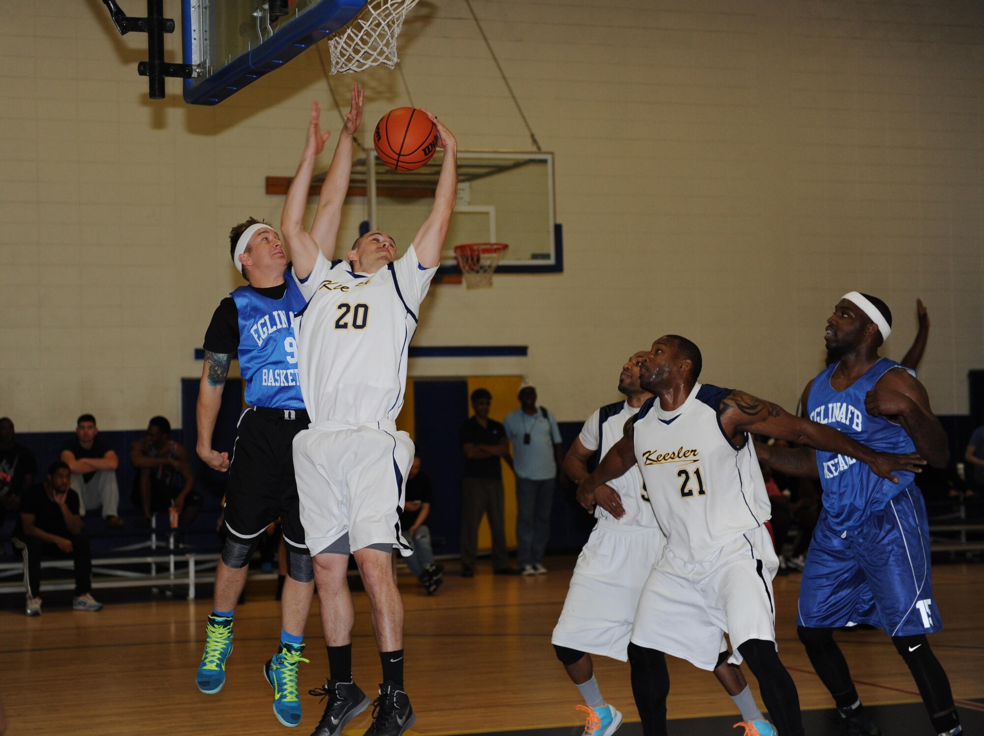 Dominic San Felippe, Dragon Fitness Center recreational aid, rebounds the ball during a men’s varsity basketball game, Oct. 24, 2015, Keesler Air Force Base, Miss. Keesler defeated Eglin, 90-87. (U.S. Air Force photo by Kemberly Groue)