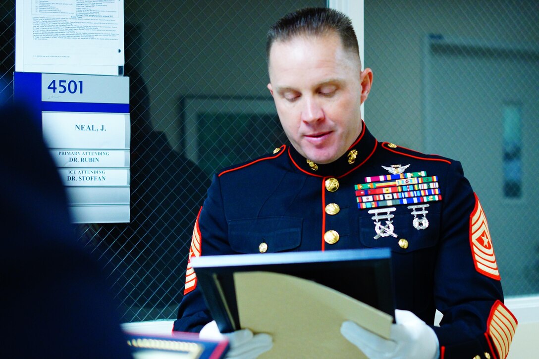 Sgt. Maj. Joseph S. Gregory, Inspector-Instructor sergeant major of 1st Battalion, 24th Marine Regiment, 4th Marine Division, reads the citation for the Congressional Gold Medal presented to the family of Montford Point Marine Mr. James Neal, Oct. 23, 2015 at Harper University Hospital in Detroit, Mich. The Congressional Gold Medal is the highest civilian honor bestowed by Congress for distinguished achievement.  The President of the United States, President Barack Obama signed into law, the legislation to award the Congressional Gold Medal to Montford Point Marines on Nov. 23, 2011.  This award recognizes Montford Point Marines' contributions to the Marine Corps and the United States of America from 1942 to 1949, when approximately 20,000 African American recruits were trained at a segregated base called Camp Montford Point. 