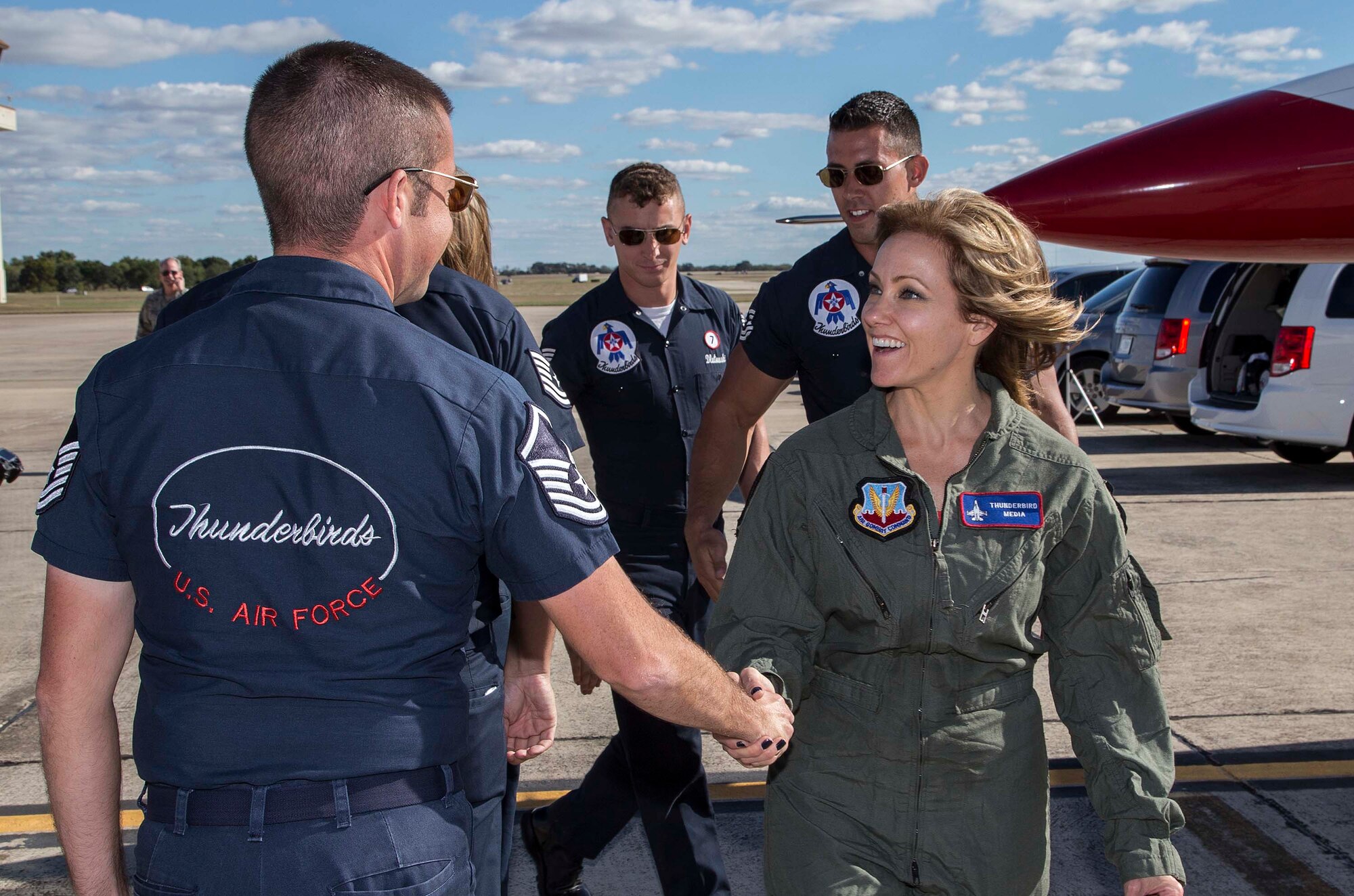 Delaine Mathieu, News 4 San Antonio co-anchor, is greeted by U.S. Air Force Air Demonstration Squadron "Thunderbirds" team members prior to a media flight Oct. 26, 2015 at Joint Base San Antonio-Randolph, Texas. The Thunderbirds are performing in the 2015 Air Show and Open House to be held at JBSA-Randolph Oct. 31 and Nov. 1. (U.S. Air Force photo by Johnny Saldivar/Released)