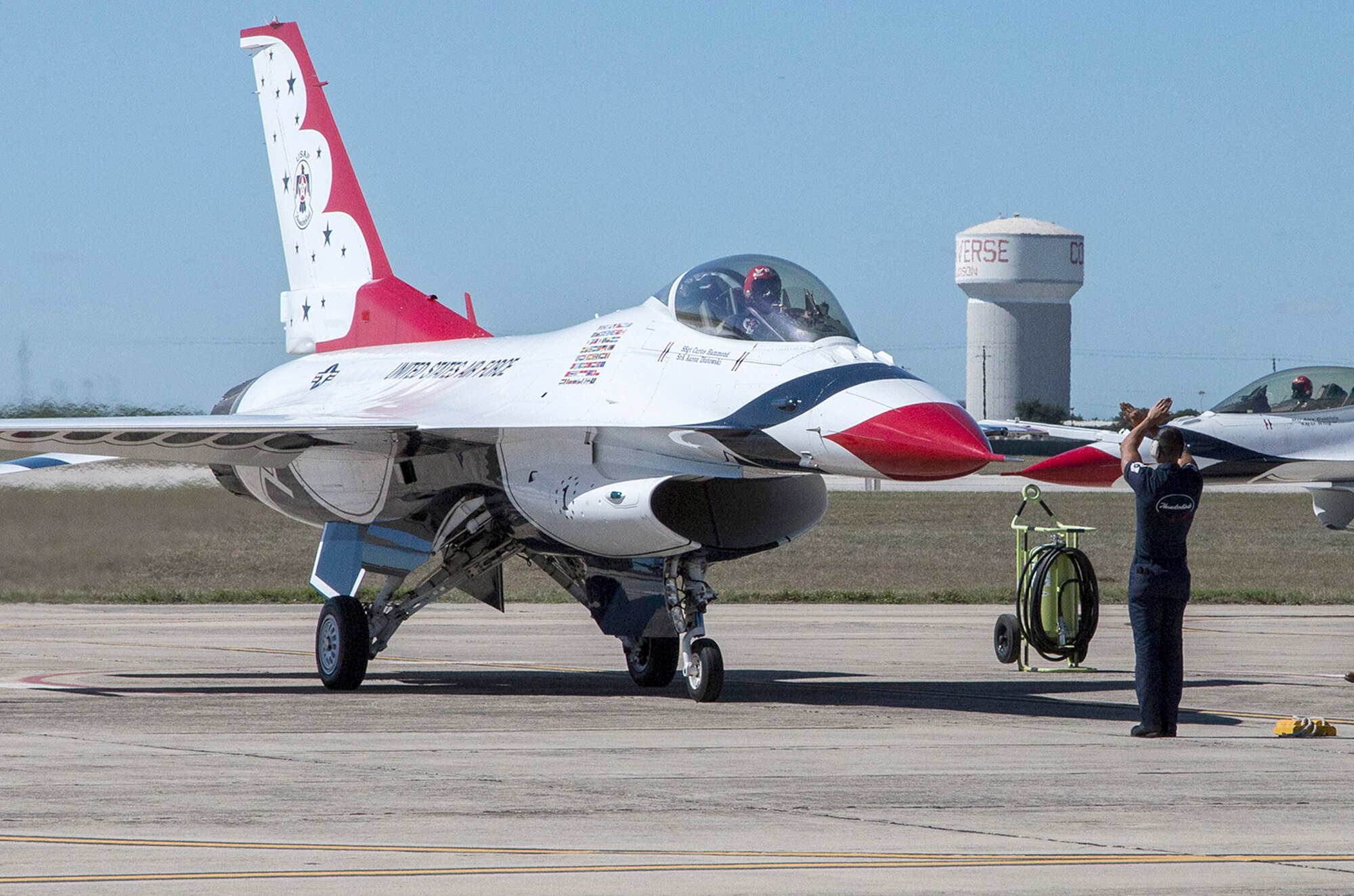 Tech. Sgt. Christopher Audet, U.S. Air Force Air Demonstration Squadron "Thunderbirds" tactical aircraft maintainer, guides a Thunderbird Oct. 26, 2015 at Joint Base San Antonio-Randolph, Texas. The Thunderbirds team members arrived in preparation for the 2015 JBSA-Randolph Air Show and Open House to be held Oct. 31 and Nov. 1.  Air shows allow the Air Force to display the capabilities of our aircraft to the American taxpayer through aerial demonstrations and static displays and allowing attendees to get up close and personal to see some of the equipment and aircraft used by the U.S. military today.  (U.S. Air Force photo by Johnny Saldivar/Released)
