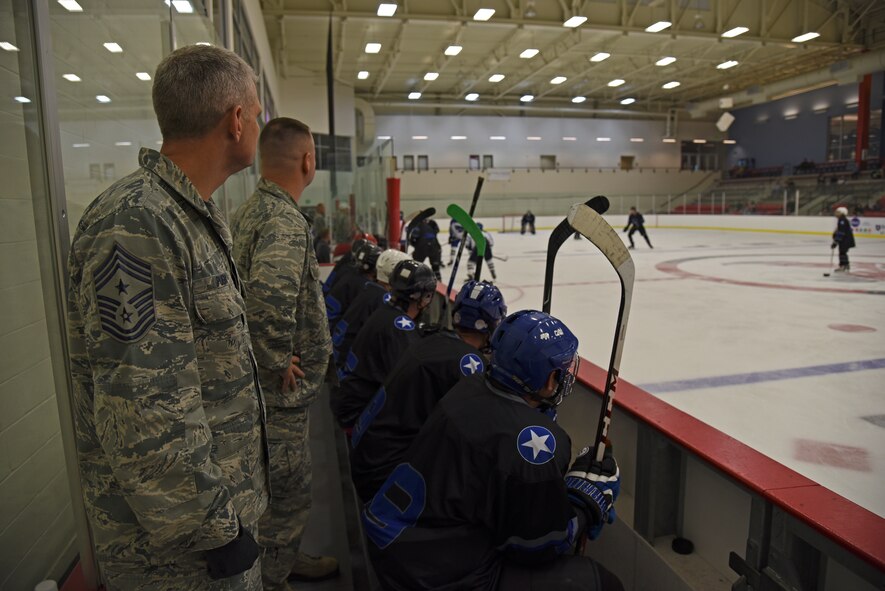 Col. Brian McDaniel, 92nd Air Refueling Wing commander, and Chief Master Sgt. Christian Pugh, 92nd ARW command chief, watch as the second period begins at the Blue and White Game Oct. 23, 2015,  at Eastern Washington University’s Recreation Center ice rink in Cheney, Wash. McDaniel and Pugh coached the blue team to victory over the white team who was coached by Col. Mark Sweitzer, 141st Mission Support Group commander, and Chief Master Sgt. David Bishop, 141st ARW command chief. (U.S. Air Force photo/Airman 1st Class Mackenzie Richardson)