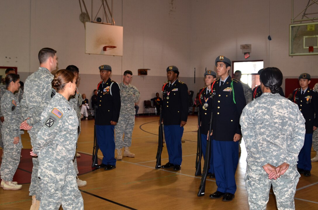 Joint Base Langley-Eustis Service members inspect the armed “knock-out drill” event during the Hampton Roads Junior ROTC Drill Competition at Northampton Community Center in Hampton, Va., Oct. 24, 2015. During the armed “knock-out drill” event, Junior ROTC cadets performed drill movements, facing elimination if they incorrectly executed a command. The last remaining participant in formation was declared the winner of the event. (U.S. Air Force photo by Master Sgt. April Wickes/Released)