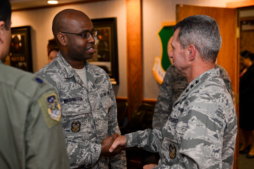 Lt. Gen. Greg Biscone, Inspector General of the Air Force, coins Master Sgt. Eric Washington, 91st I.G. wing inspection team manager, at Minot Air Force Base, N.D., Oct. 26, 2015.  The purpose of Biscone’s visit was to collect feedback on I.G. policies and procedures.
(U.S. Air Force photo/Airman 1st Class J.T. Armstrong)
