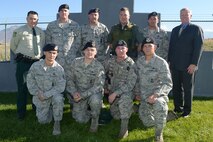 Military working dog handlers from the 75th Security Forces Squadron pose with U.S. Forest Service members at Hill Air Force Base, Utah, Oct. 26, 2015. The handlers received special recognition from the Forest Service for their actions in aiding an injured person in the Uinta-Wasatch-Cache National Forest last September. Front row: Staff Sgts. Cody Kassebaum, Dustin Cain, Matt McCarty and Christopher Keilman; back row: Intermountain Region Law Enforcement and Investigations Commander Larry Hall, Staff Sgt. Tyler Schlittler, Tech. Sgt. Eric Magnuson,  Law Enforcement Officer Darren Schiedel, Staff Sgt. Chad Bunda and Intermountain Region Special Agent in Charge Scott Harris. Not pictured: Staff Sgt. Dustin Braddy. (U.S. Air Force photo by Alex R. Lloyd)