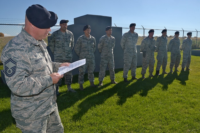 Senior Master Sgt. Douglas F. Clayton, 75th Security Forces Squadron, reads a U.S. Forest Service letter of recognition to 75th SFS Airmen at Hill Air Force Base, Utah, Oct. 26, 2015. The Airmen, military working dog handlers, were training with the Forest Service in the Uinta-Wasatch-Cache National Forest when an emergency medical call was received. To aid an injured person, they carried packs, a litter and other supplies more than two miles at elevations of 7,500 feet. Once at the scene, they coordinated a safe landing for an emergency helicopter and then carried the victim to the helicopter via an extremely narrow trail with steep drop-offs. (U.S. Air Force photo by Alex R. Lloyd)