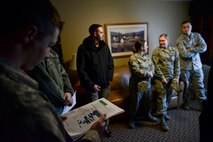 Airman 1st Class Christian Sullivan, 5th Bomb Wing photojournalist, reads an alternate light source chart at a mock crime scene at Minot Air Force Base, N.D., Oct. 22, 2015. Office of Special Investigations agents use alternate light sources and filters to detect substances not visible to the naked eye.  (U.S. Air Force photo/Airman 1st Class J.T. Armstrong)