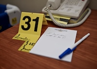 Evidence from a mock crime scene sits on a desk as part of training led by the Office of Special Investigations at Minot Air Force Base, N.D., Oct. 22, 2015. The two-part training day lasted about four hours and consisted of a slide presentation and a mock crime scene. (U.S. Air Force photo/Airman 1st Class J.T. Armstrong)