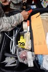 Airmen look through a case of tools from the Office of Special Investigations at Minot Air Force Base, N.D., Oct. 22, 2015. OSI agents led training to share their process for photographing a crime scene. (U.S. Air Force photo/Airman 1st Class J. T. Armstrong)