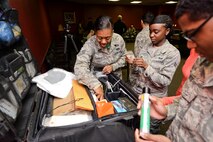 Airmen look through a case of tools from the Office of Special Investigations at Minot Air Force Base, N.D., Oct. 22, 2015. OSI agents led training to share their process for photographing a crime scene. (U.S. Air Force photo/Airman 1st Class J. T. Armstrong)