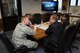 U.S. Air Force Col. Joe McFall, 52nd Fighter Wing commander, gives a presentation on the mission of the 52nd FW to Randolph Stich, Rhineland-Palatinate deputy minister of the interior and Elena Mazzola, German department liaison of military forces Oct. 22, 2015, at Spangdahlem Air Base, Germany. Recently appointed, Stich received a base tour as the new state secretary for the ministry of interior to become familiar with the 52nd FW mission. (U.S. Air Force photo by Staff Sgt. Christopher Ruano/Released)
