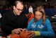 Master Sgt. John McCauley, 319th Medical Support Squadron systems flight chief, and daughter Annika, 12, decorate a pumpkin together at Liberty Scare on Grand Forks Air Force Base, North Dakota, Oct. 23, 2015. Airmen and their families were able to celebrate Halloween with games and festivities at the event. (U.S. Air Force photo by Airman 1st Class Bonnie Grantham/released)