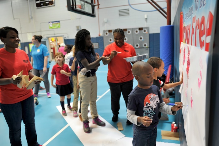 Children with the youth center paint their hands to signify their pledge to be drug free at the youth center, Joint Base Charleston, S.C., Oct. 23, 2015. The annual Red Ribbon Week campaign began with more than 20 children reciting an oath to be drug free and signing with their hand print. (U.S. Air Force photo/Tech. Sgt. Renae Pittman)