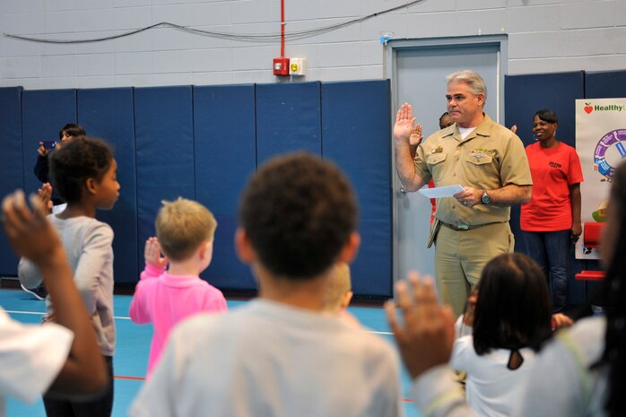 U.S. Navy Capt. Timothy Sparks, 628th Air Base Wing vice commander, administers an oath to children at the youth center at Joint Base Charleston, S.C., Oct. 23, 2015. The oath was a promise to be drug free, and was commemorated with a hand print and signature. (U.S. Air Force photo/Tech. Sgt. Renae Pittman)