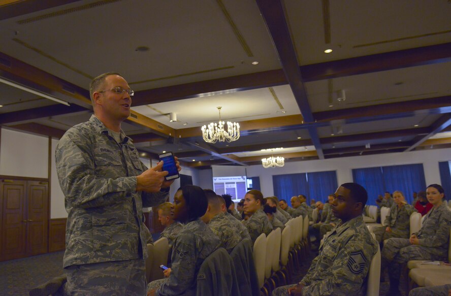 Brig. Gen. Jon T. Thomas, 86th Airlift Wing commander, demonstrates using the new Ramstein app during a commander’s call Oct. 20, 2015, at Ramstein Air Base, Germany. The new app, described by Thomas as “easy to learn” and “intuitive,” is available free on Apple and Android app stores and provides information about the Kaiserslautern Military Community. (U.S. Air Force photo/Airman 1st Class Lane T. Plummer)