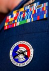 A base Honor Guard’s badge is displayed on U.S. Air Force 1st Lt. Lewis Tartt, officer in charge of the base Honor Guard and 52nd Equipment Maintenance Squadron flight commander, after the base Honor Guard training graduation ceremony inside the base theater at Spangdahlem Air Base, Germany, Oct. 23, 2015. The graduates conducted several ceremonial performances, including presentation of the colors, the flag folding ceremony and reciting of the Honor Guard Charge during their graduation ceremony. (U.S. Air Force photo by Airman 1st Class Timothy Kim/Released) 