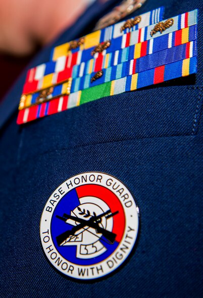 A base Honor Guard’s badge is displayed on U.S. Air Force 1st Lt. Lewis Tartt, officer in charge of the base Honor Guard and 52nd Equipment Maintenance Squadron flight commander, after the base Honor Guard training graduation ceremony inside the base theater at Spangdahlem Air Base, Germany, Oct. 23, 2015. The graduates conducted several ceremonial performances, including presentation of the colors, the flag folding ceremony and reciting of the Honor Guard Charge during their graduation ceremony. (U.S. Air Force photo by Airman 1st Class Timothy Kim/Released) 