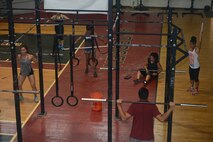 A functional fitness class takes place Oct. 26, 2015, at Andersen Air Force Base, Guam. The workout involves various exercises to include gymnastics, power lifting, cardio and Olympic weight lifting. (U.S. Air Force photo by Airman 1st Class Arielle Vasquez/Released)