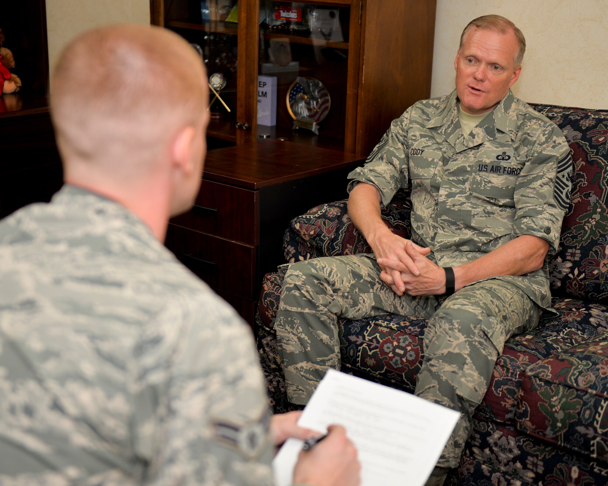 Chief Master Sgt. of the Air Force James A. Cody shares insight about Air Force issues with Airman 1st Class Curt Beach, 2nd Bomb Wing Public Affairs photojournalist, at Barksdale Air Force Base, La., Oct. 22, 2015. Cody represents the highest enlisted level of leadership, and as such, provides direction for the enlisted force and represents their interests, as appropriate, to the American public, and to those in all levels of government. (U.S. Air Force photo/Airman 1st Class Mozer O. Da Cunha) 