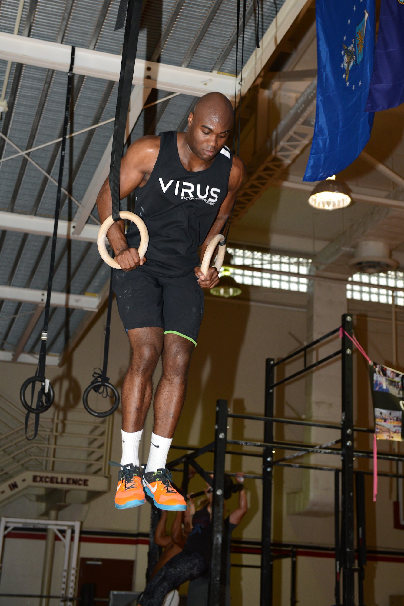 First Lt. Alex Johnson, 23rd Expeditionary Bomb Squadron electronic warfare officer, performs muscle-ups Oct. 21, 2015, at Andersen Air Force Base, Guam. Johnson does functional fitness at least five times a week, and follows a program that guides him during his daily exercises. (U.S. Air Force photo by Airman 1st Class Arielle Vasquez/Released)
