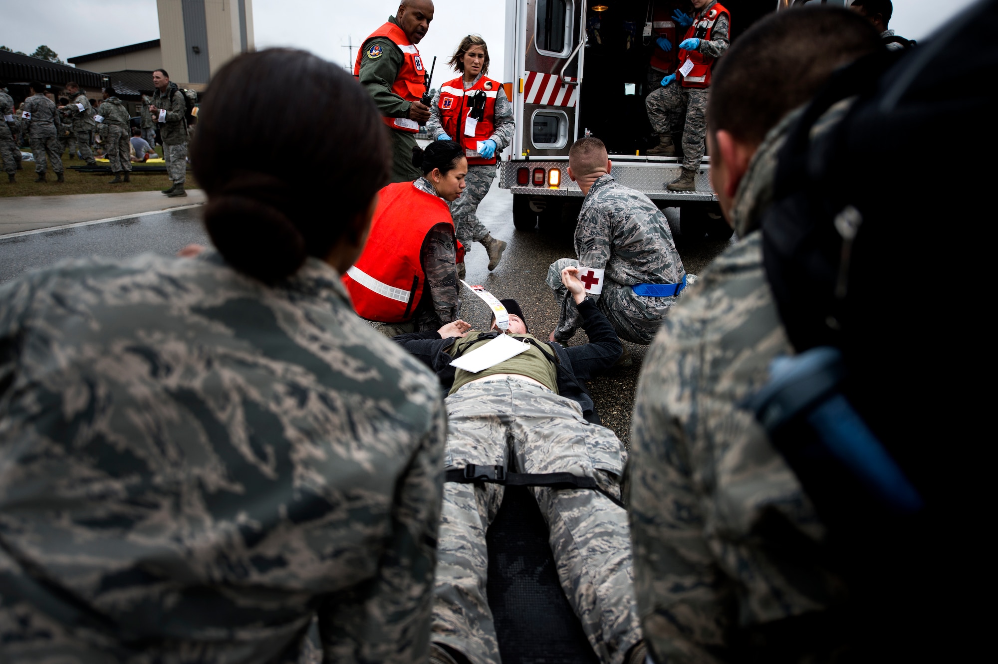 Airmen from the 23d Medical Group lift a patient on a litter into an ambulance during a major accident response exercise, Oct. 27, 2015, at Moody Air Force Base, Ga. The exercise also included support from emergency medical support teams from the local community. (U.S. Air Force photo by Senior Airman Ryan Callaghan/Released)

