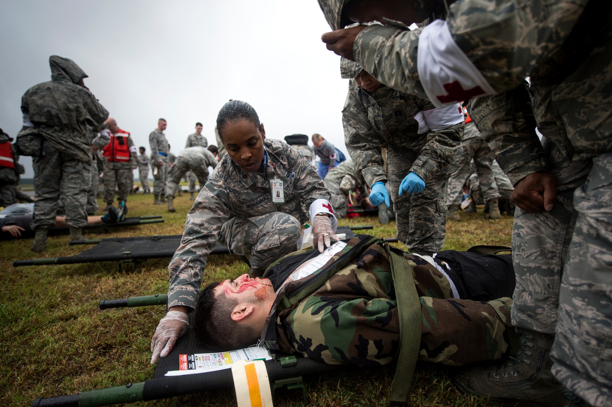 U.S. Air Force Maj. Saudah Muhammad, 23d Medical Operations Squadron family health flight commander, tends to a patient during a major accident response exercise, Oct. 27, 2015, at Moody Air Force Base, Ga. The exercise was designed to test a wide spectrum of Moody’s capabilities including responding to an aircraft crash and treating patients on-scene. (U.S. Air Force photo by Senior Airman Ryan Callaghan/Released)

