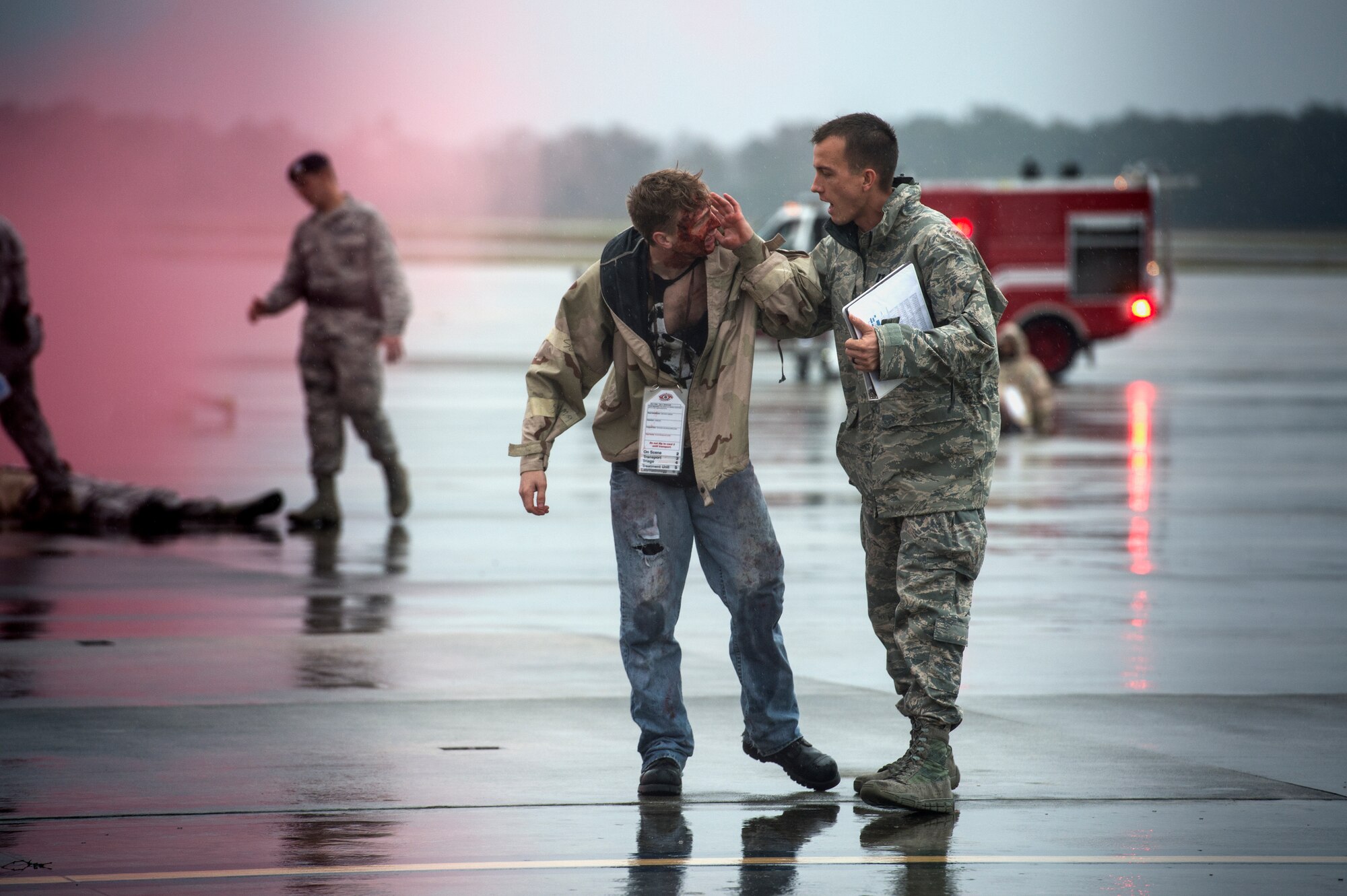 Airmen from the 23d Security Forces Squadron evacuate the walking casualties from a simulated aircraft crash scene during a major accident response exercise, Oct. 27, 2015, at Moody Air Force Base, Ga. The Security Forces Airmen were among the first responders and assisted the injured people until they could be treated by medical personnel. (U.S. Air Force photo by Senior Airman Ryan Callaghan/Released)
